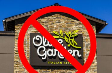 Olive Garden restaurant sign with a "no" sign over it.