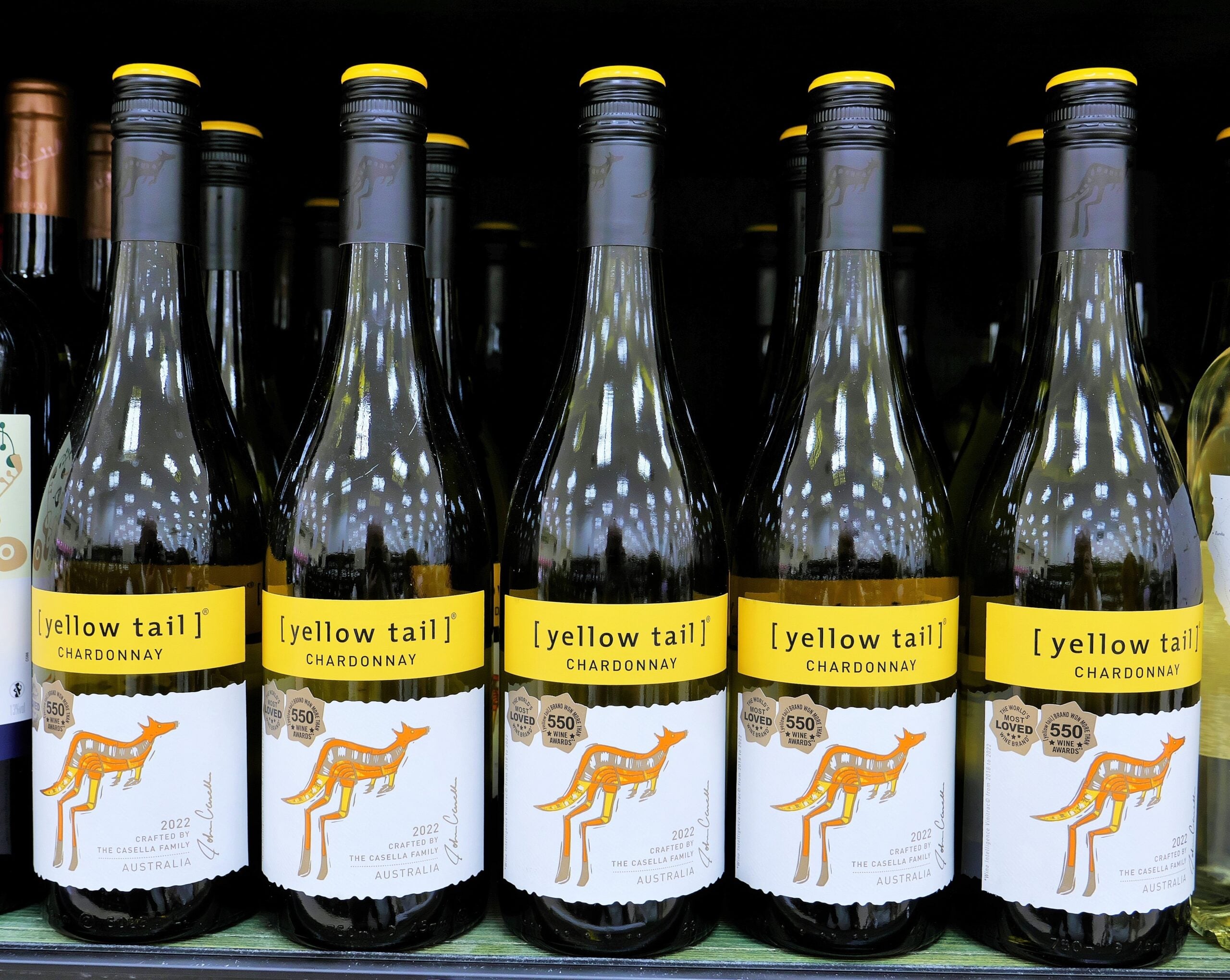 Several bottles of Yellow Tail wine on display at a grocery store. 