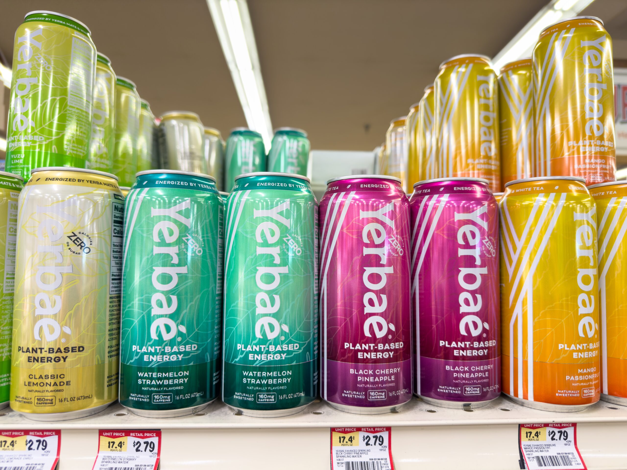 Assorted cans of Yerbaé on a supermarket shelf.