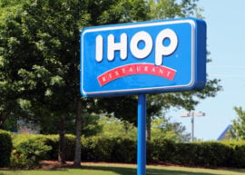 IHOP sign with a tree behind it