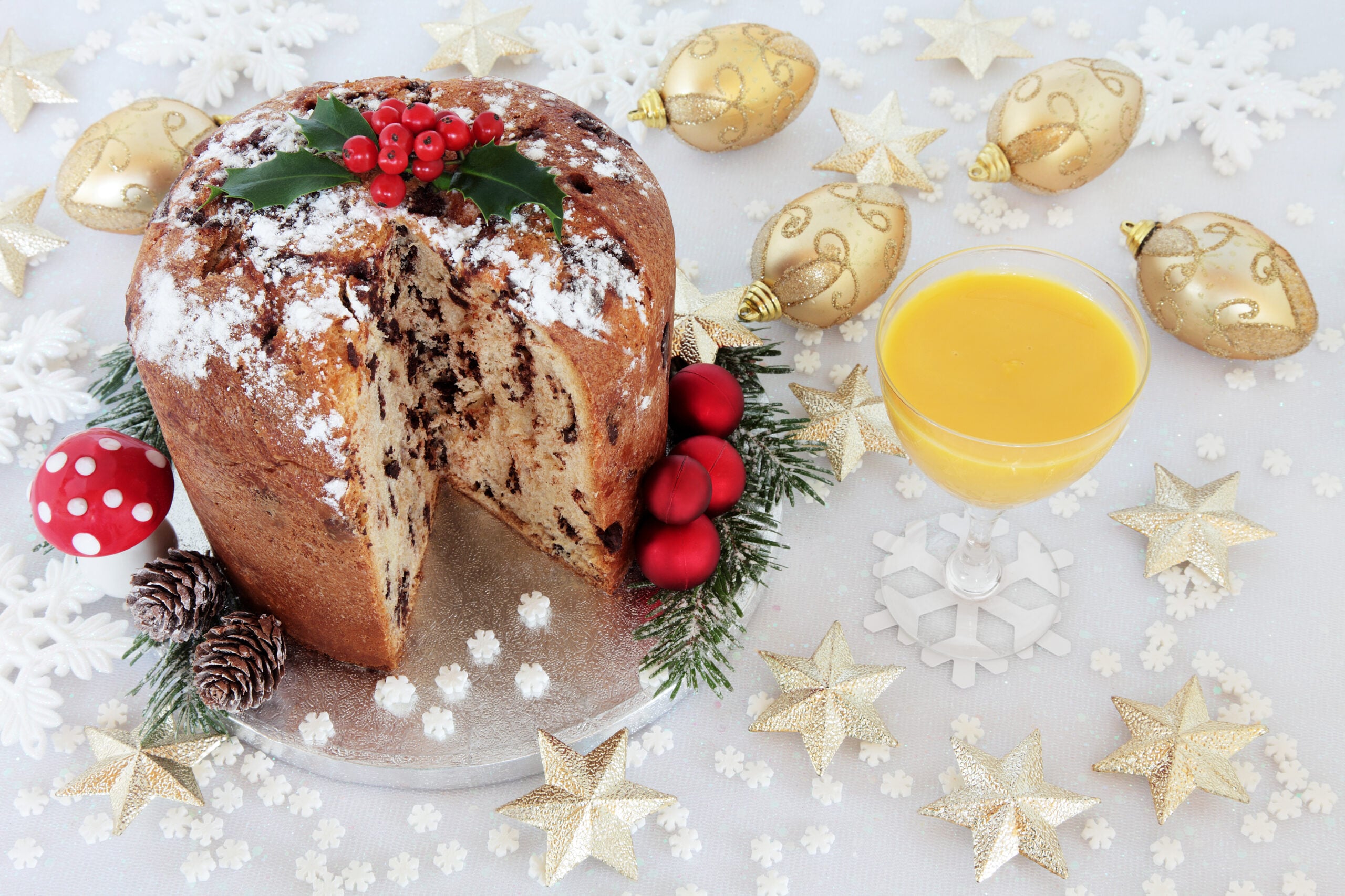 A chocolate panettone Christmas cake and Yule nog on a decorated table. nettone Christmas cake with