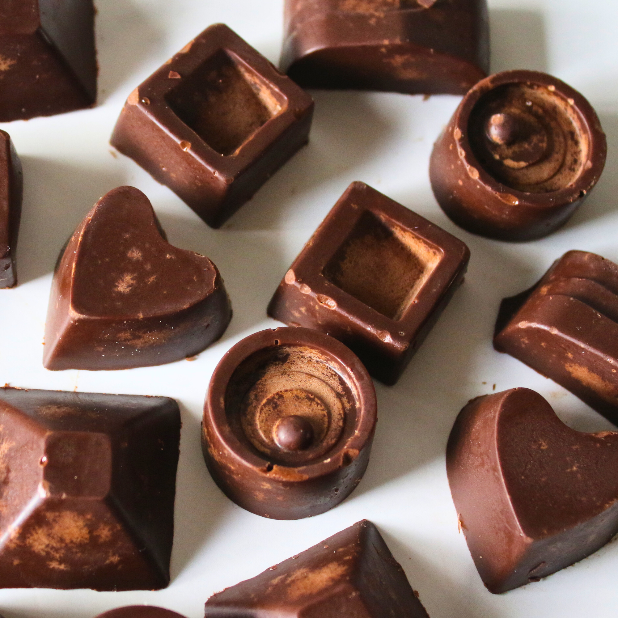Homemade keto chocolates on a white plate.