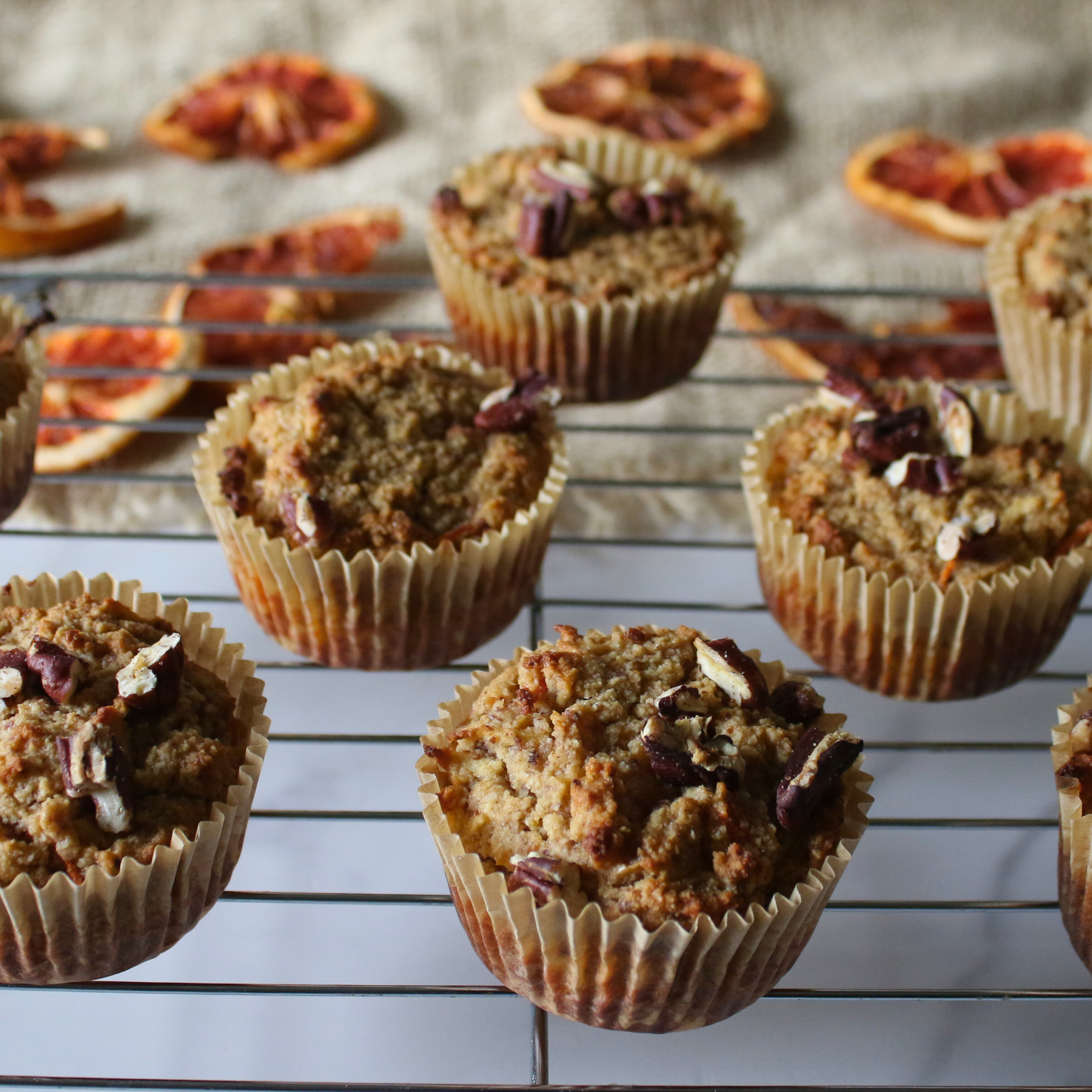 Baked homemade morning glory muffins on a wire rack.