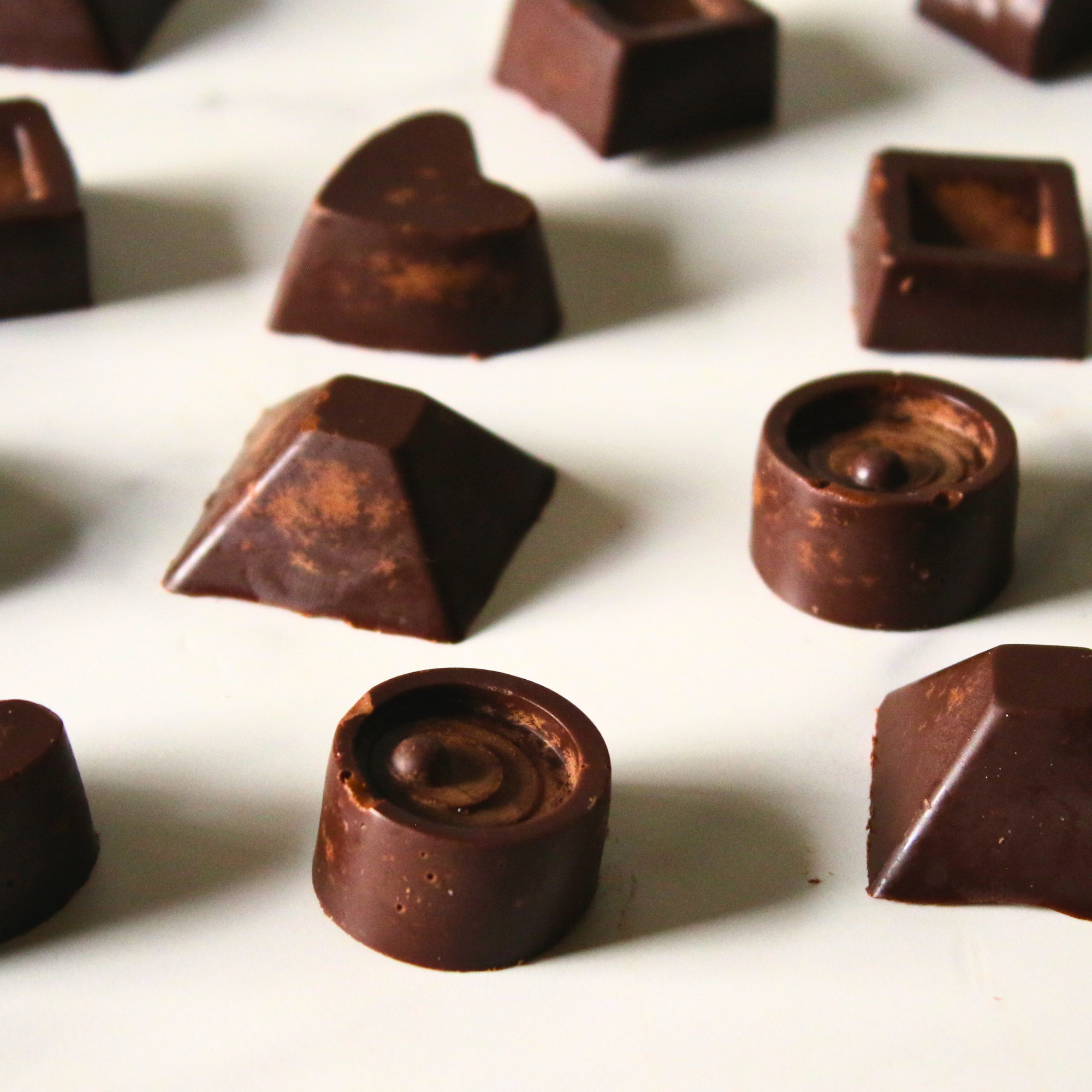 Homemade keto chocolates on a white plate.