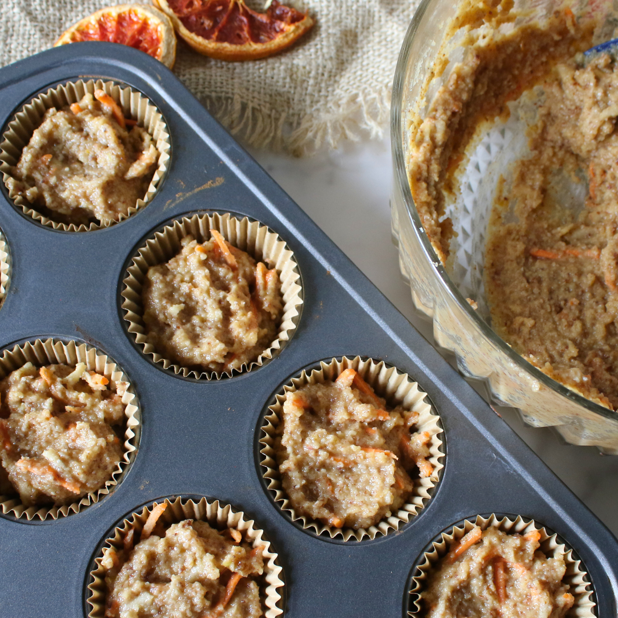 Muffin batter in a muffin pan.