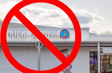 Duck Donuts sign with a big red "cancel" symbol over it