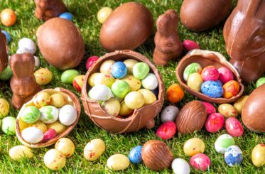 Various Easter candy on a green background.