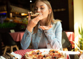 Woman eating pizza