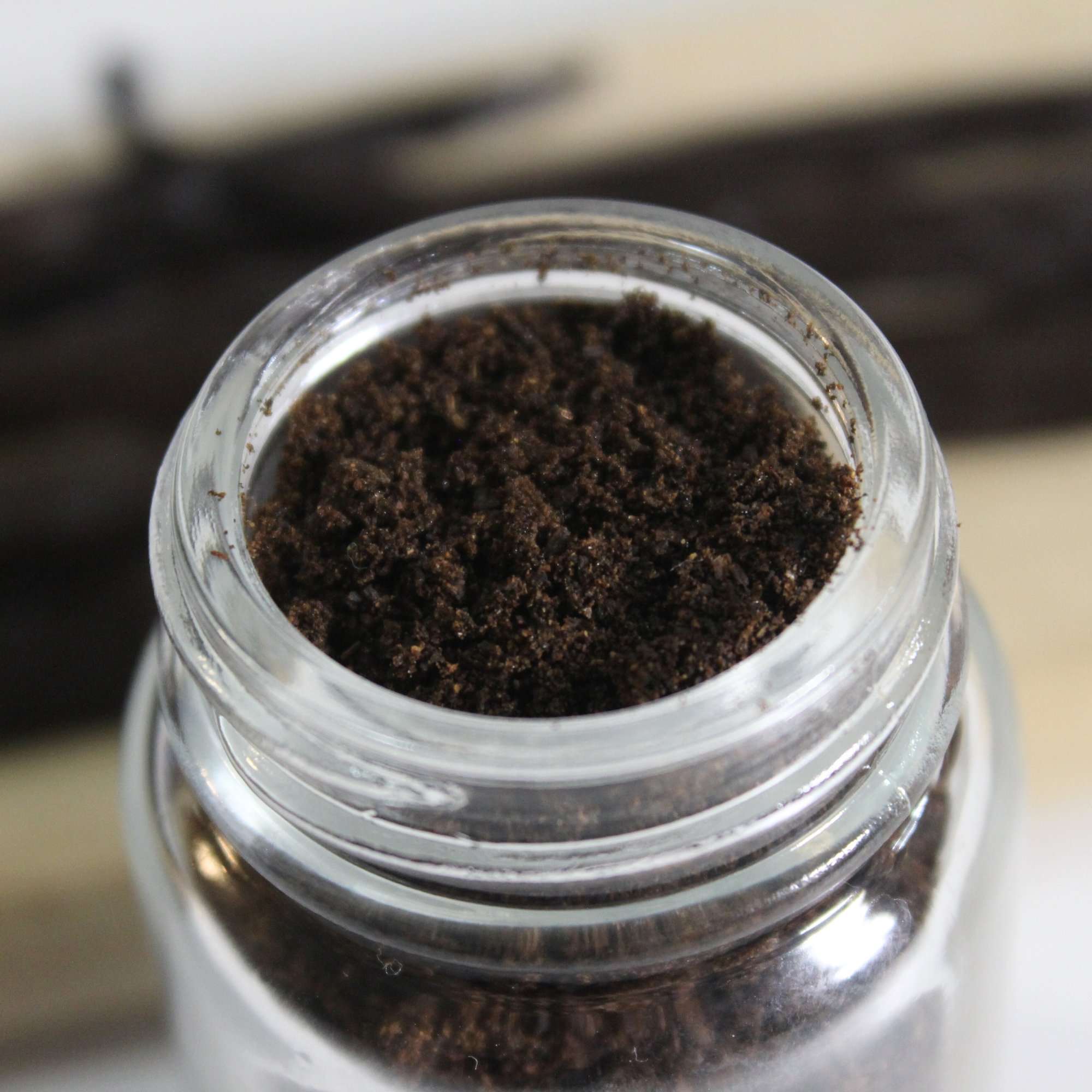 Vanilla bean powder in a glass jar.