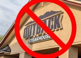 Outback Steakhouse sign with a red prohibition symbol over it.