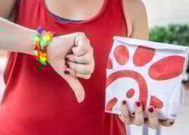 Woman giving a thumbs down to a Chick-fil-A sandwich