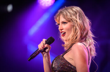 Taylor Swift singing into a microphone