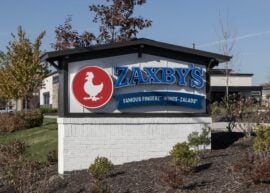 Zaxby's sign with red chicken logo outdoors.