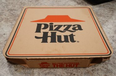 Pizza Hut logo on a brown pizza box