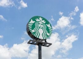 Starbucks sign against sky