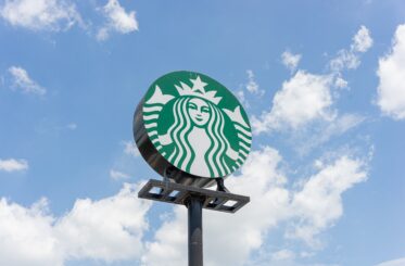 Starbucks sign against sky