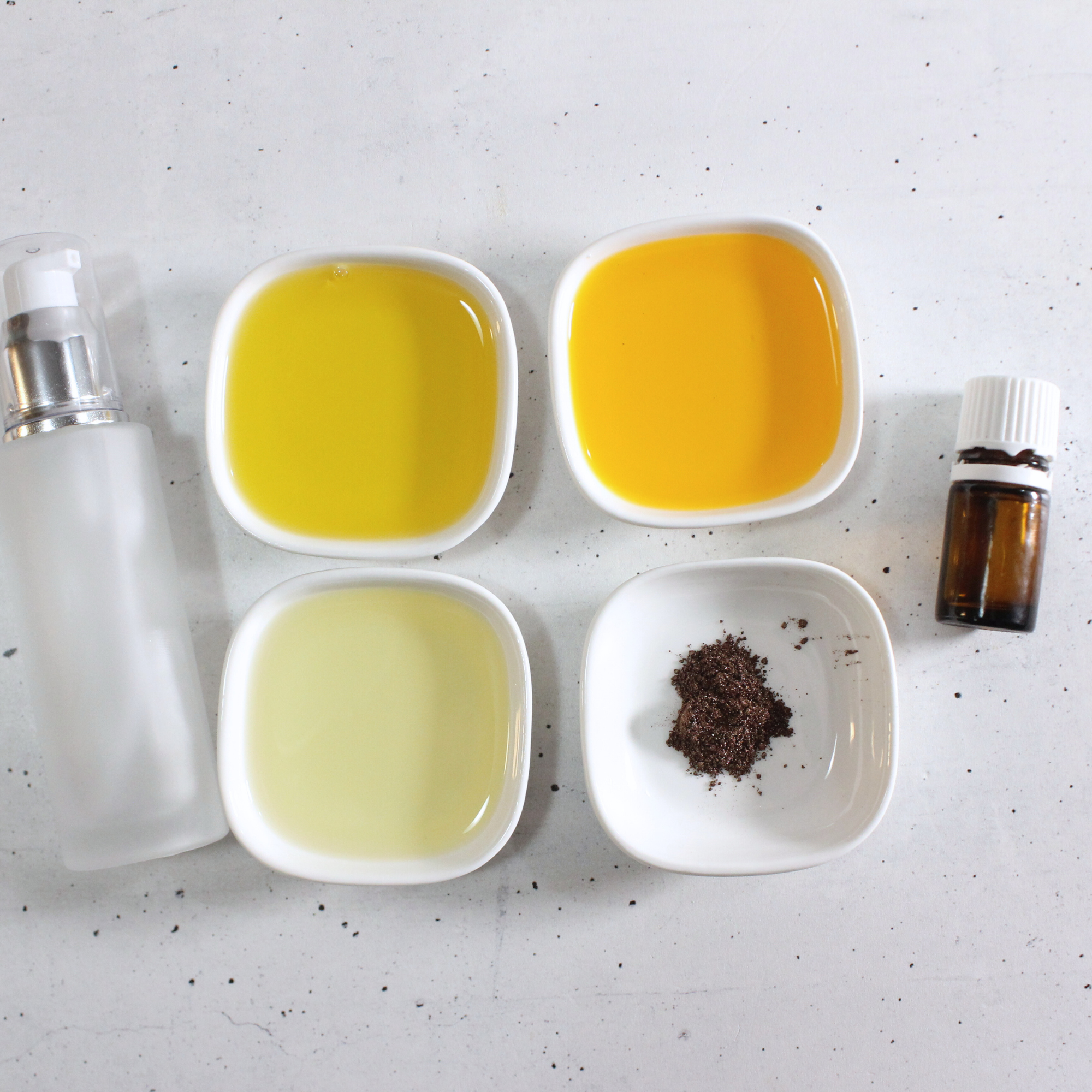 Ingredients to make homemade tanning oil, including carrier oils like avocado oil and carrot seed oil.