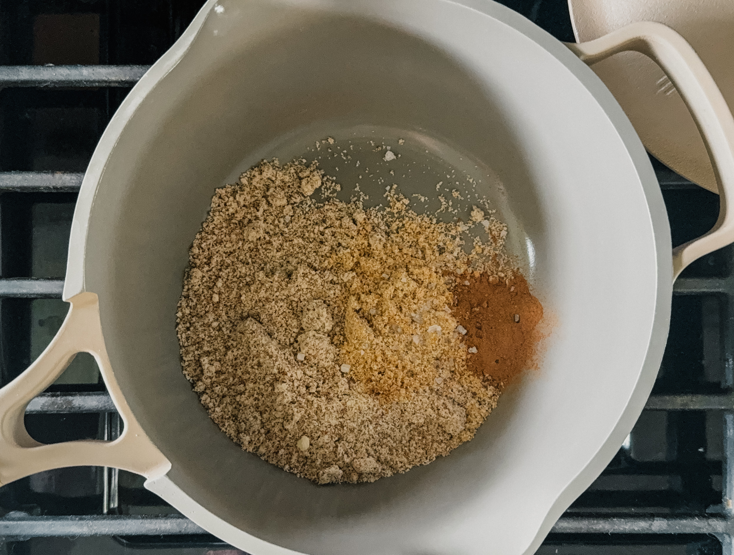 Dry ingredients in a pot on a stovetop.