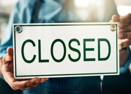 Closed sign...man holding it.