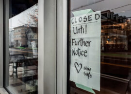 Window of storefront with sign reading 'Closed until further notice. Stay safe.'