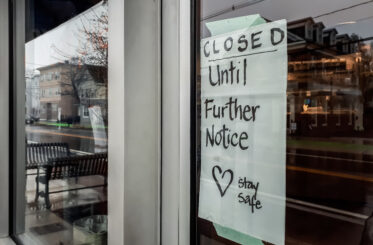 Window of storefront with sign reading 'Closed until further notice. Stay safe.'