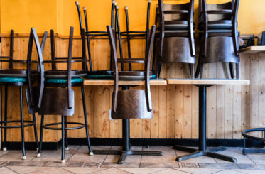 Chairs upside down on table in closed restaurant