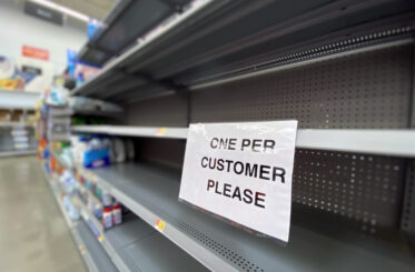 Empty store with "one per customer please" on a small card
