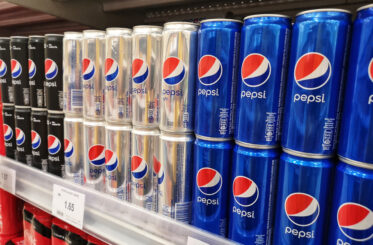 Cans of pepsi on a store shelf