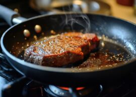 Steak sizzling in a pan