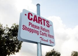 shopping cart sign with red letters