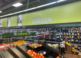 Inside of a Kroger, with lots of fruits and vegetables