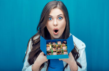 Woman holding box of chocolate candies