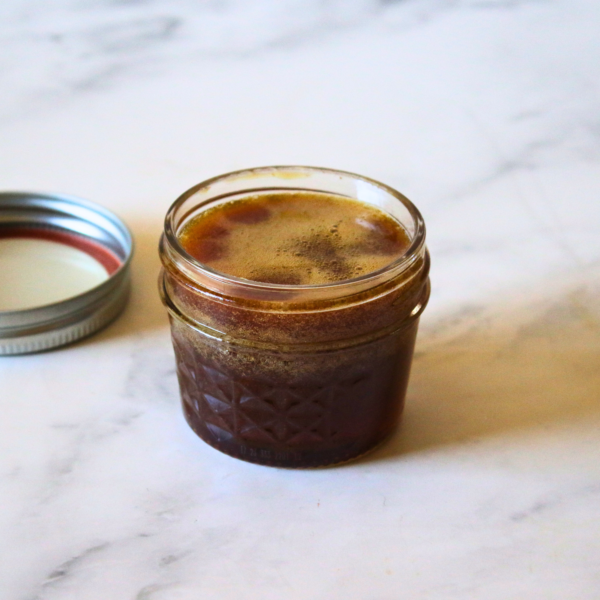 Homemade hot honey in a small glass jar.