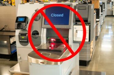 upermarket closing time, the self check-out station with "Closed" sign on the screen and a red not permitted sign over it