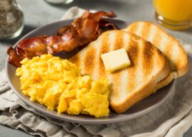 Breakfast plate with eggs, toast, and bacon