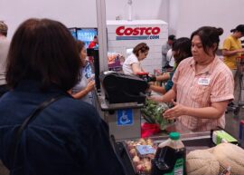 Costco employee helping customer in the checkout line