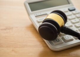Judge's gavel next to a calculator
