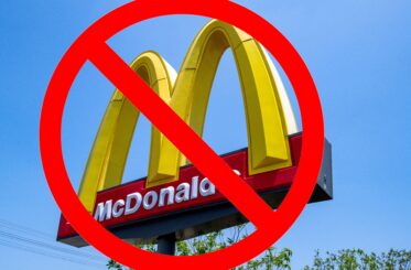 McDonald's restaurant sign with a "no" symbol over it.