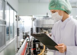 Quality control engineers work in the production and bottling facility for fruit juice