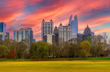 Atlanta City skyline with skyscrapers, buildings, and dramatic sunset clouds over Piedmont Park in the Capital of the U.S. State of Georgia