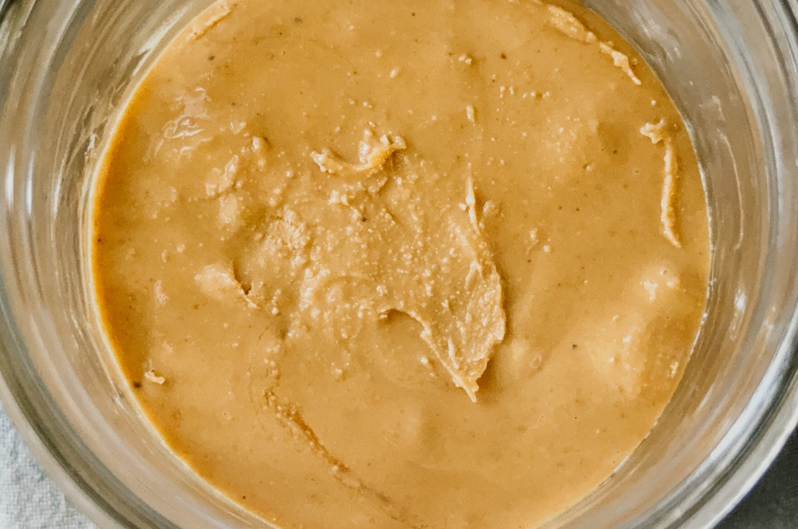 Freshly made cashew butter in a jar.