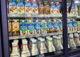 View of plant-based milk options in a refrigerated case