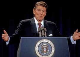 Ronald Reagan giving a speech behind a podium.