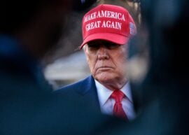 President Donald Trump with a "Make America Great Again" hat.