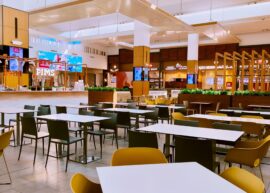 Spacious modern food court with empty tables and chairs, ideal for dining concepts.